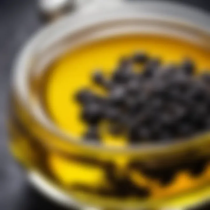 Close-up of black seed oil in a glass container