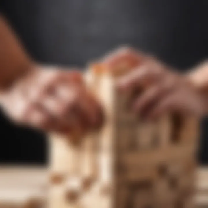 Close-up of a hand carefully removing a Jenga block