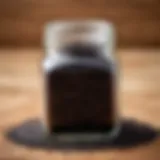 Dried black cumin seeds displayed in a glass jar